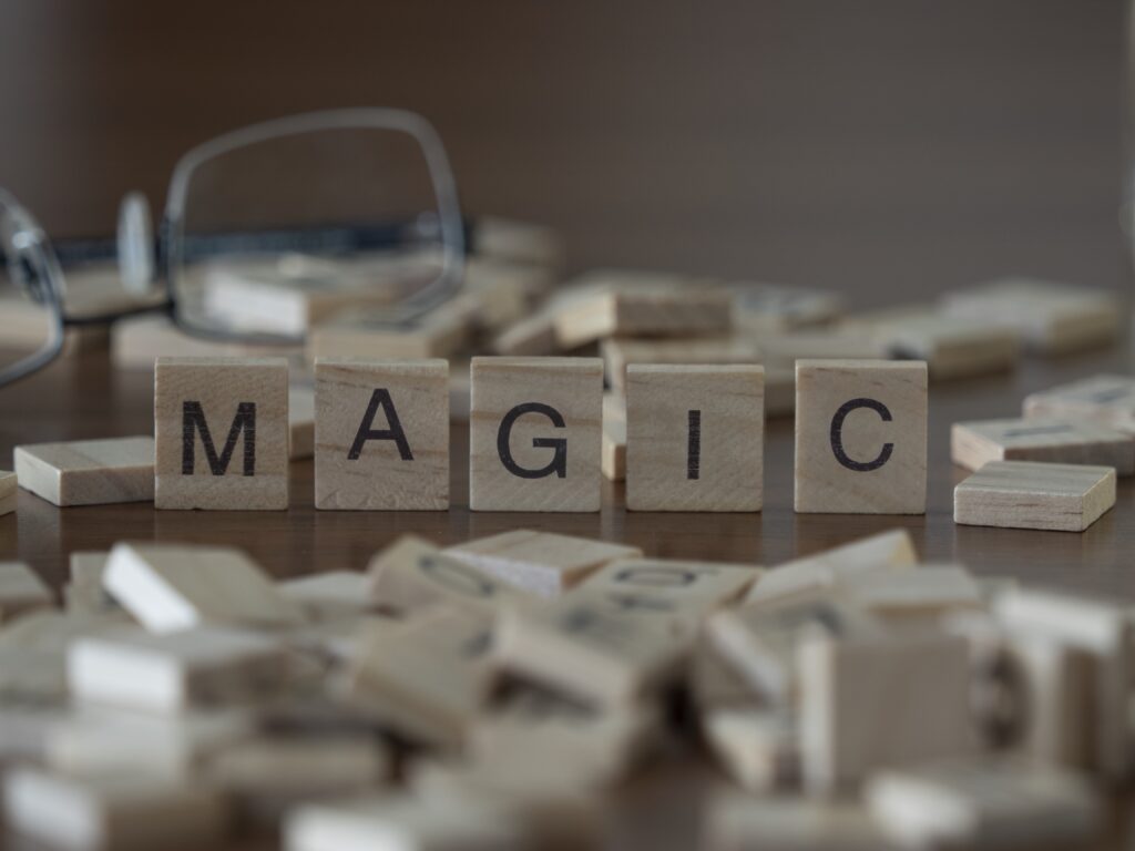 the concept of magic represented by wooden letter tiles